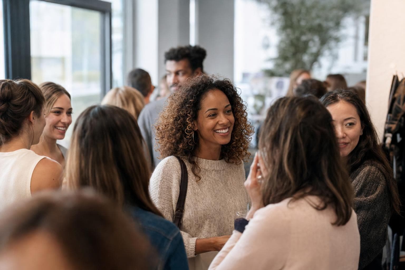 A photo of a lively group of loyal customers gathered together at a warm, friendly business event.
