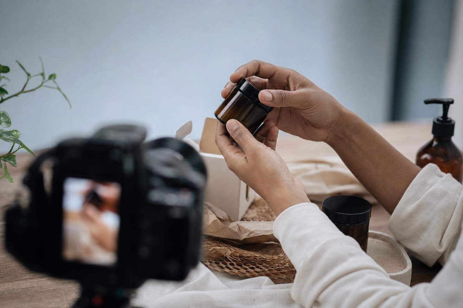 A photo of hands demonstrating a product up close for a video, with no face shown.