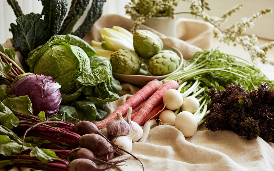 Fresh seasonal vegetables arranged on linen