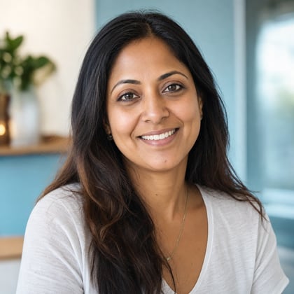 Priya Nair, founder of a yoga studio, smiling warmly