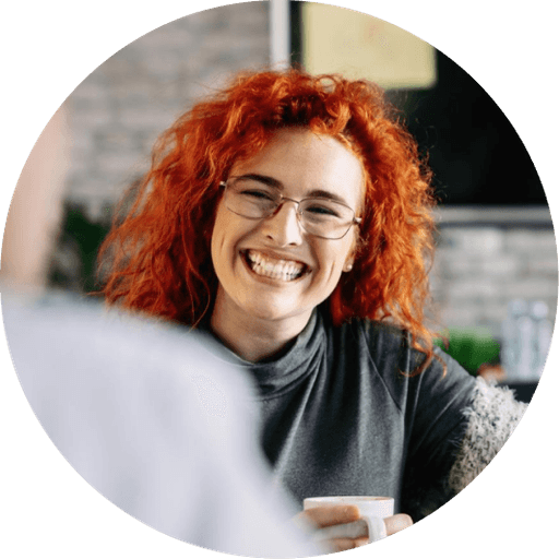 Team member with a coffee mug at her desk