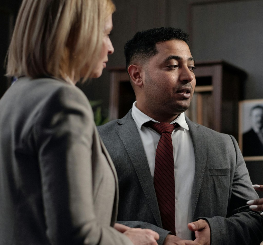 Two attorneys reviewing documents at a conference table