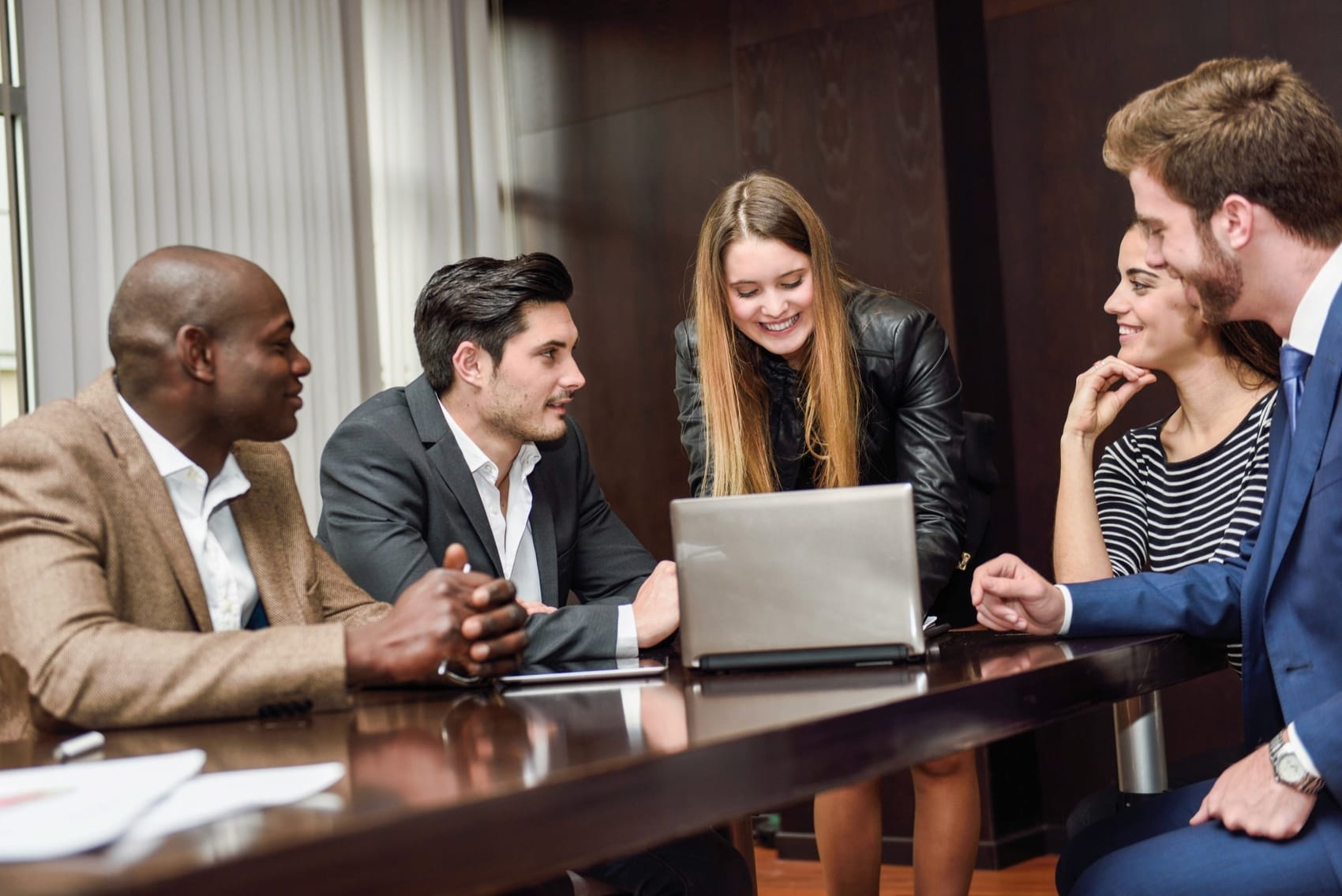 Colleagues discussing documents at a table