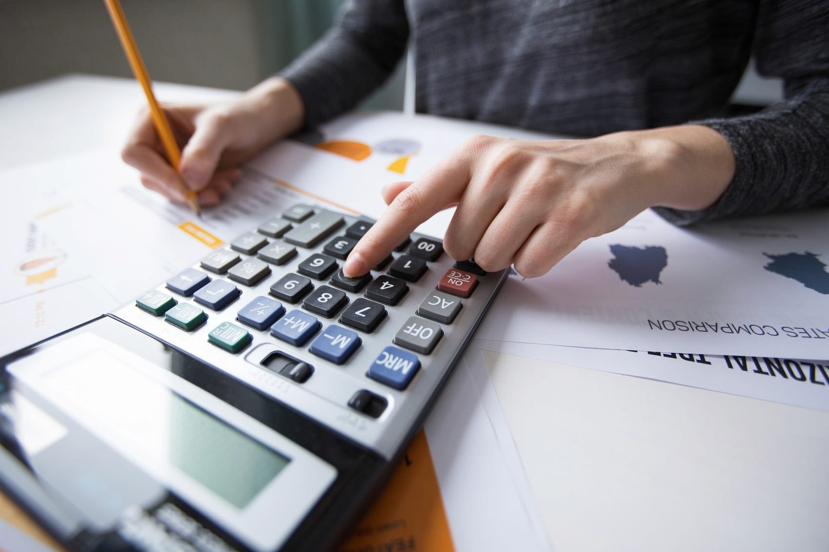 Accountant working through tax figures with a calculator