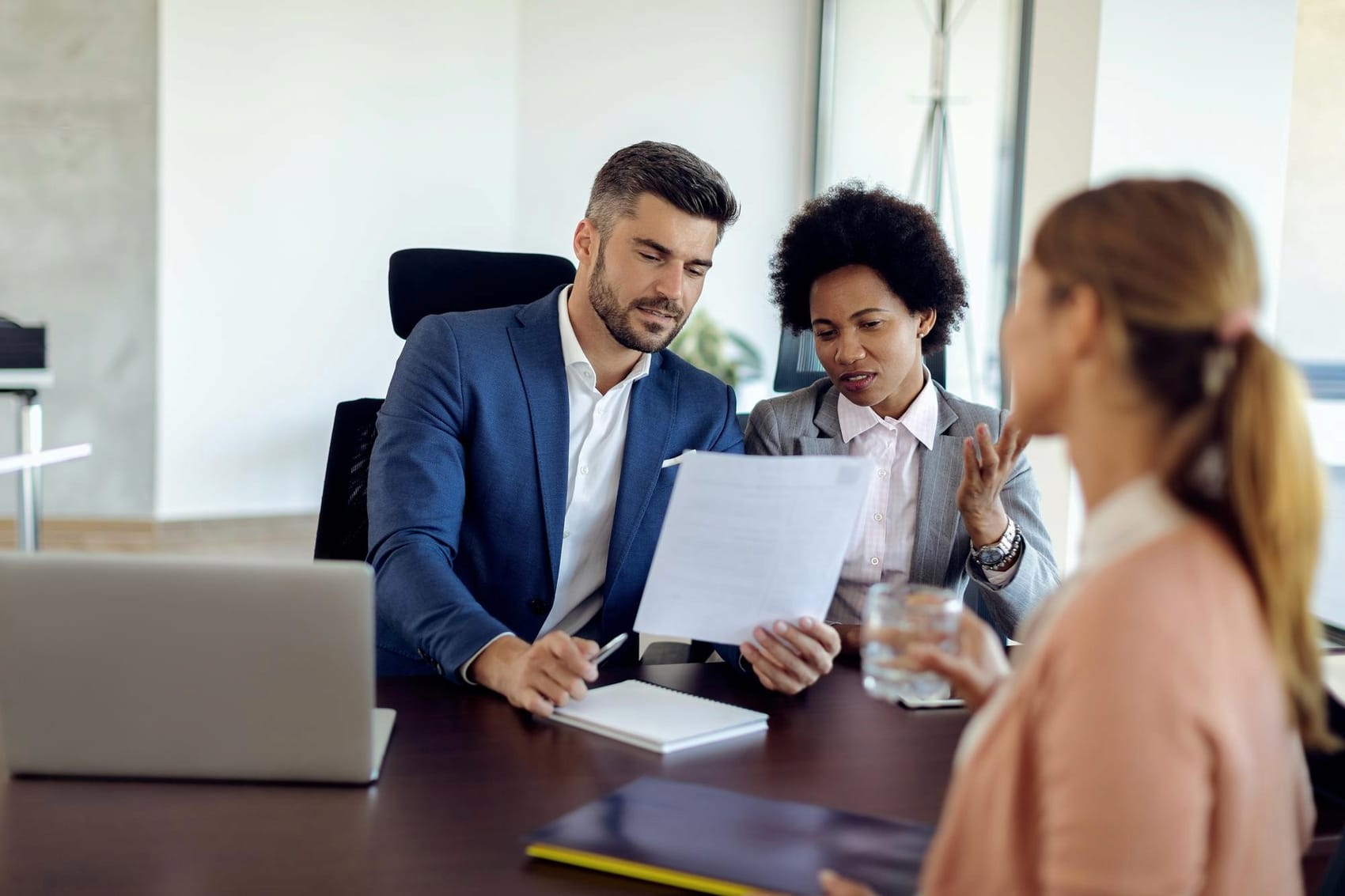 A workplace team in discussion around a conference table